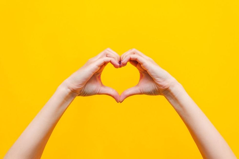 Female hands showing a heart shape