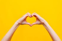 Female hands showing a heart shape