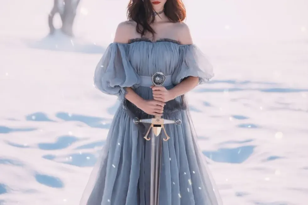 Female warrior in a beautiful dress is holding her sword
