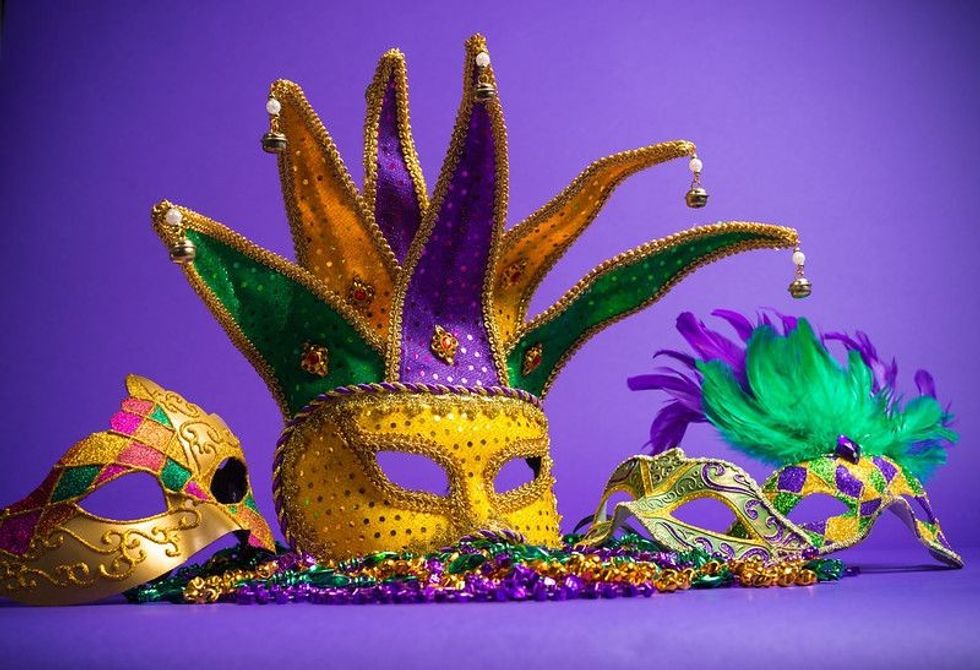 Festive Grouping of mardi gras, venetian or carnivale mask on a purple background.