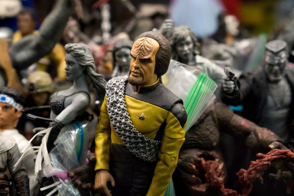 Figures in an old retro toy shop with a star trek character