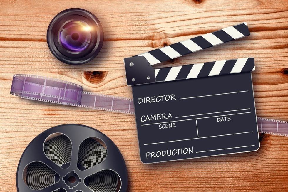 Film reel, lens and movie clapper in retro composition 3D illustration