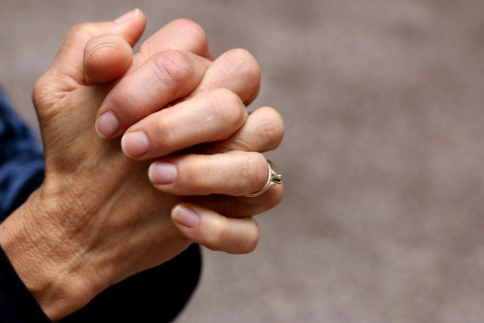 Focused shot of praying hands.