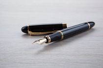 Fountain pen on a grey table.