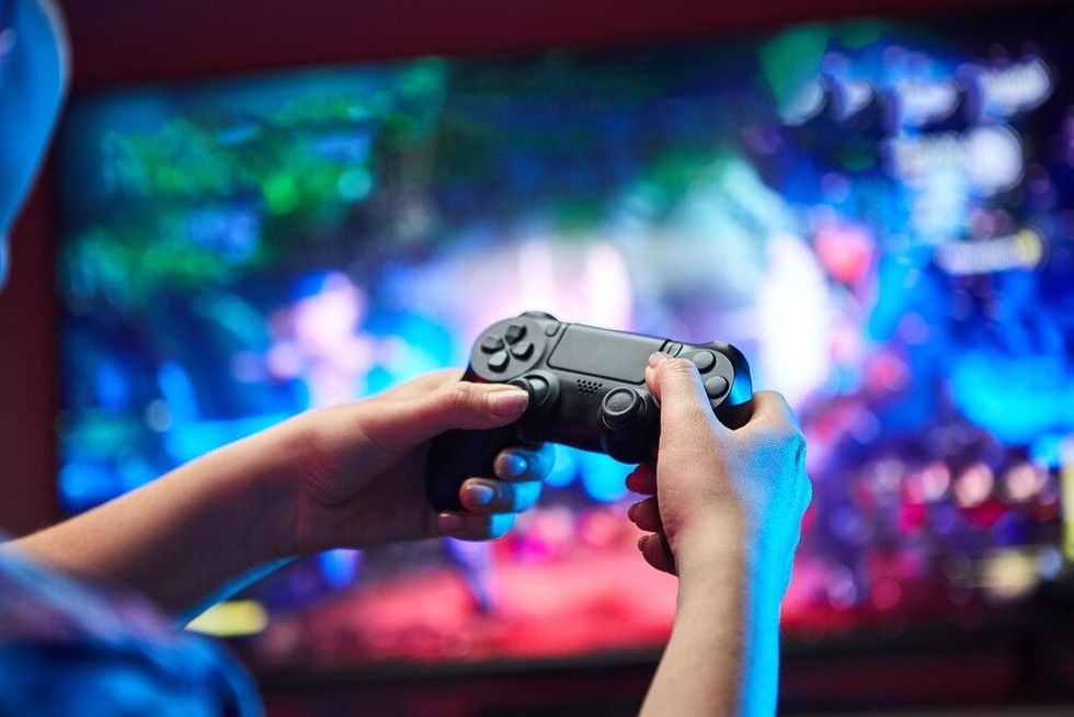 Gamer holding Videogame Joystick Console in hands.