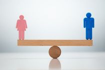 Gender Equality Concept. Male And Female Balancing On Seesaw