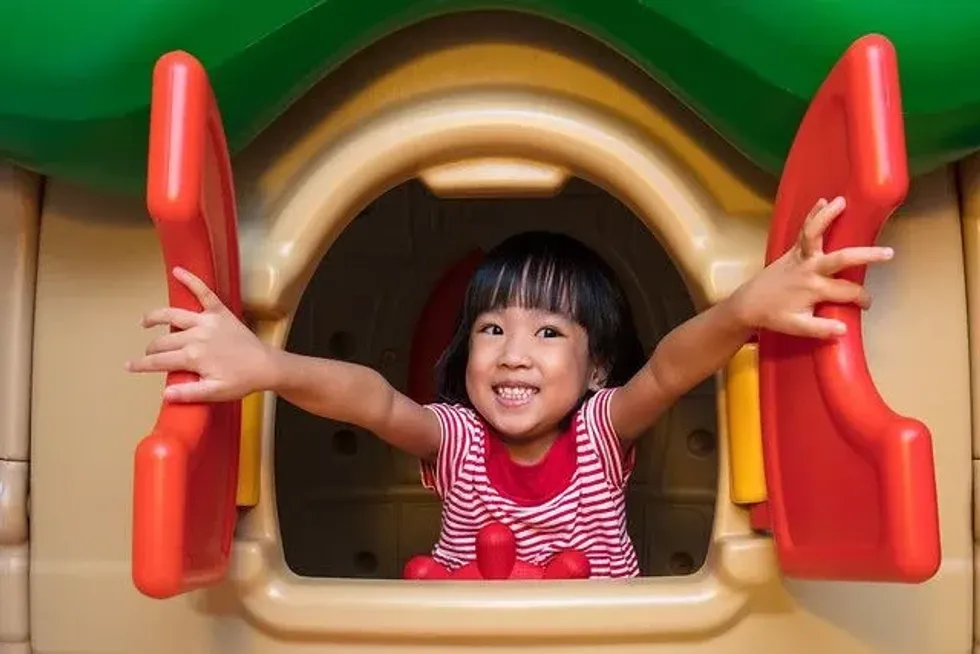 Girl enjoying a play in a playhouse
