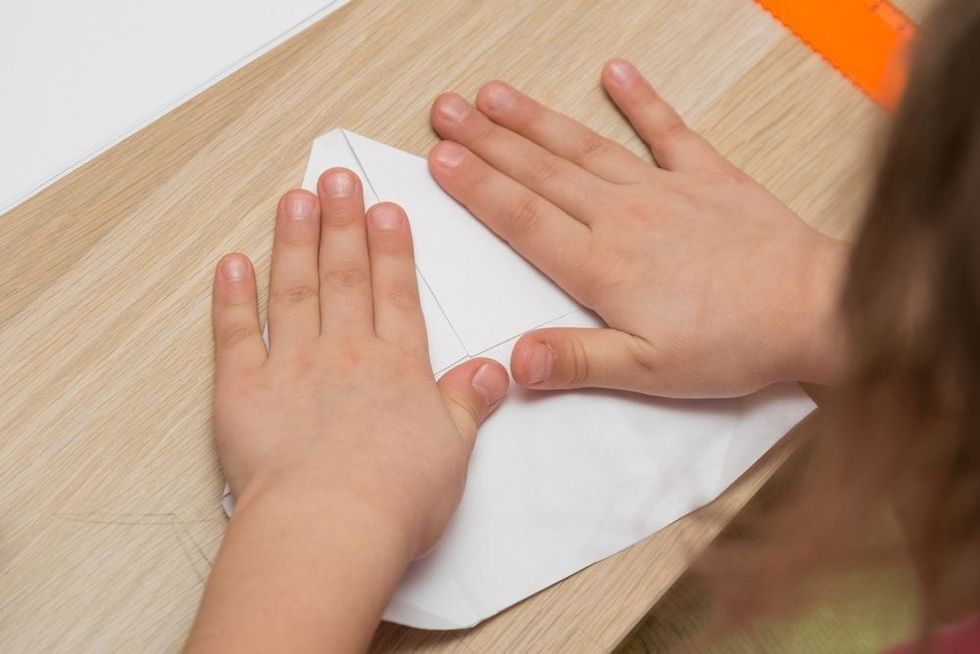 Girl is engaged in origami.