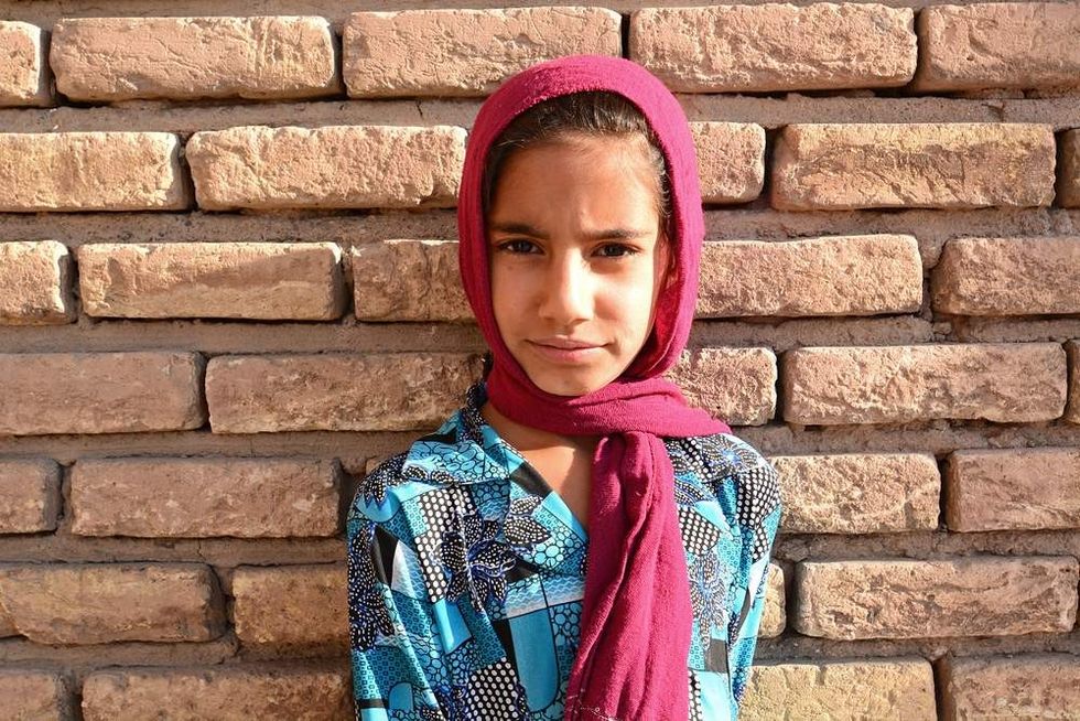 Girl wearing a scarf and blue shirt