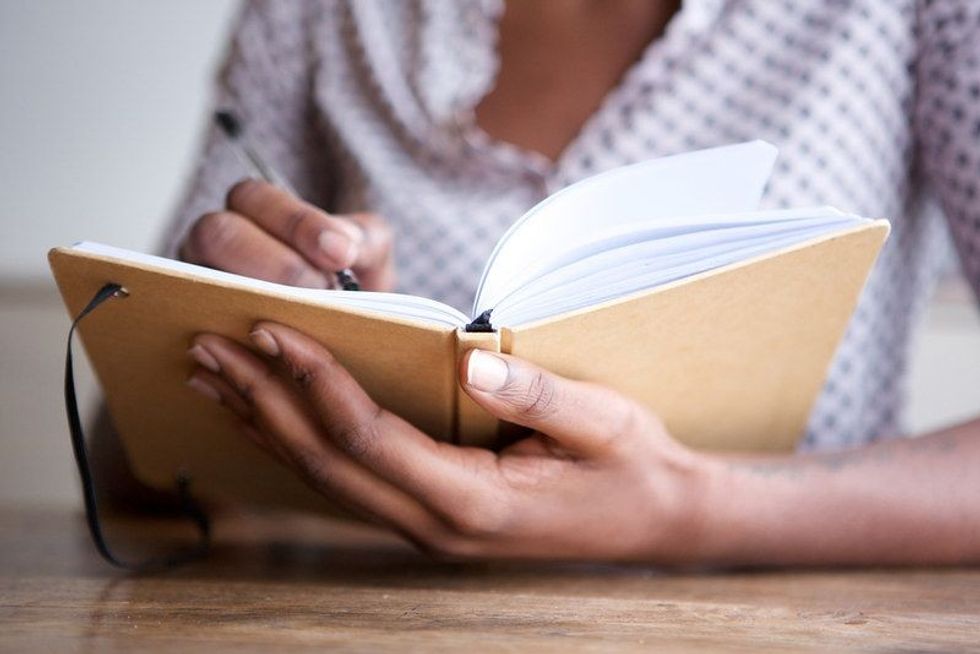 Girl writing in book