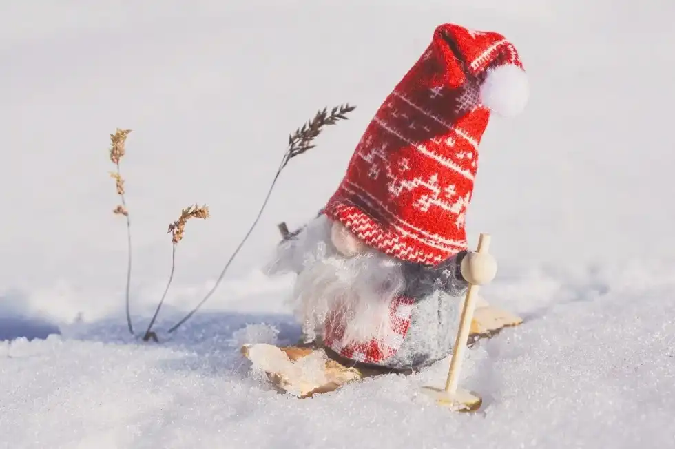 Gnome dwarf figurine on snow