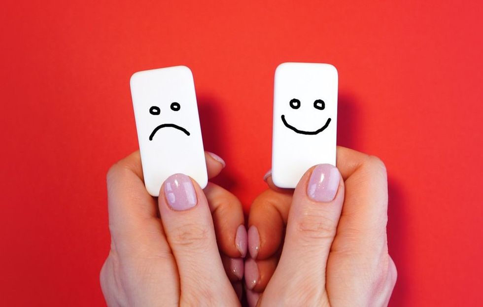 Good mood and bad mood concept with blocks and smiles in a hands