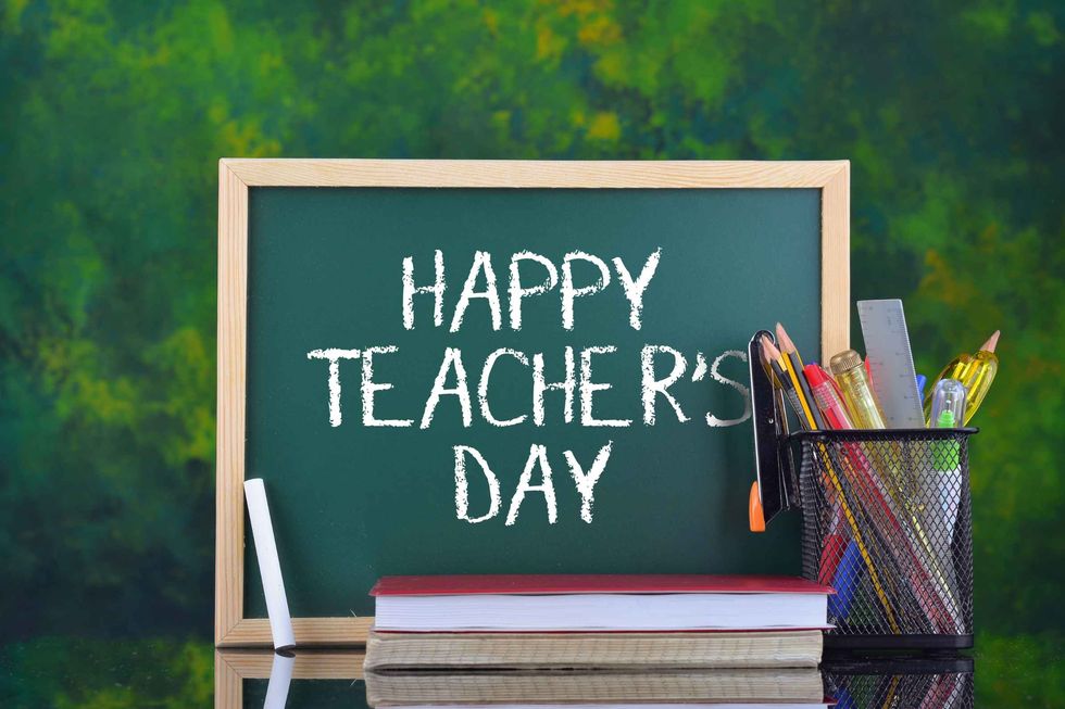 Green writing board with words Happy Teacher's Day