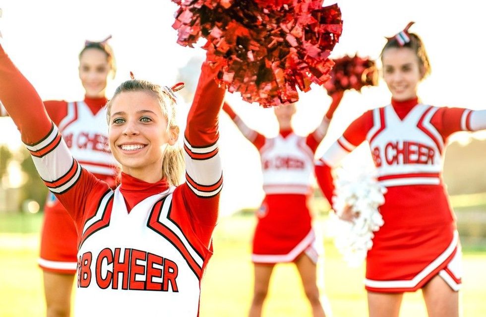 Group of female cheerleaders performing outdoors