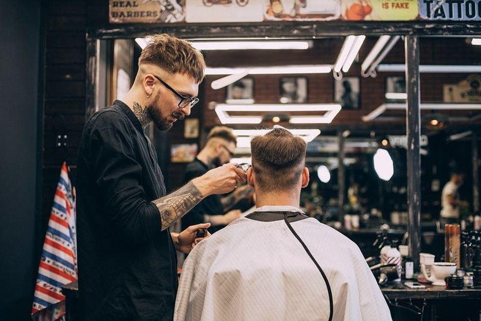 Hairdresser cutting hair of the customer