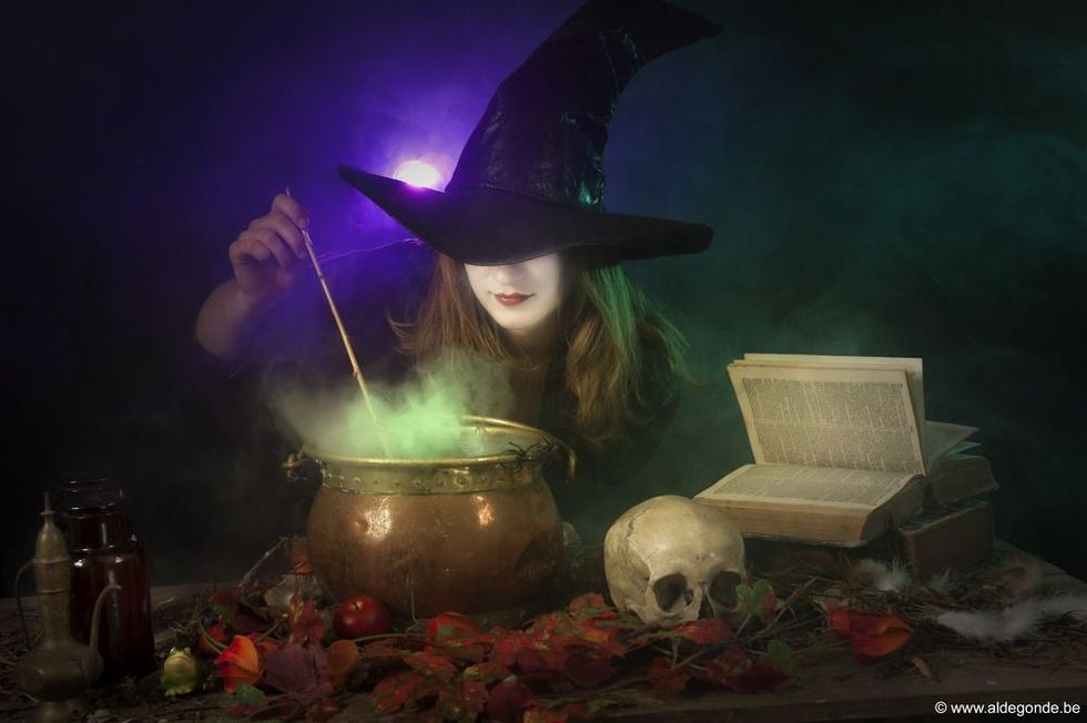 Halloween witch boiling a potion in a caldron