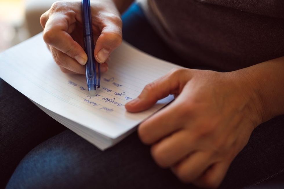 Hand writes a pen in a notebook