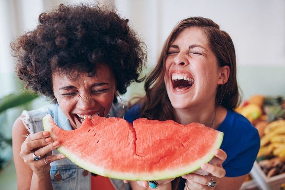 Happy adults enjoying watermelon