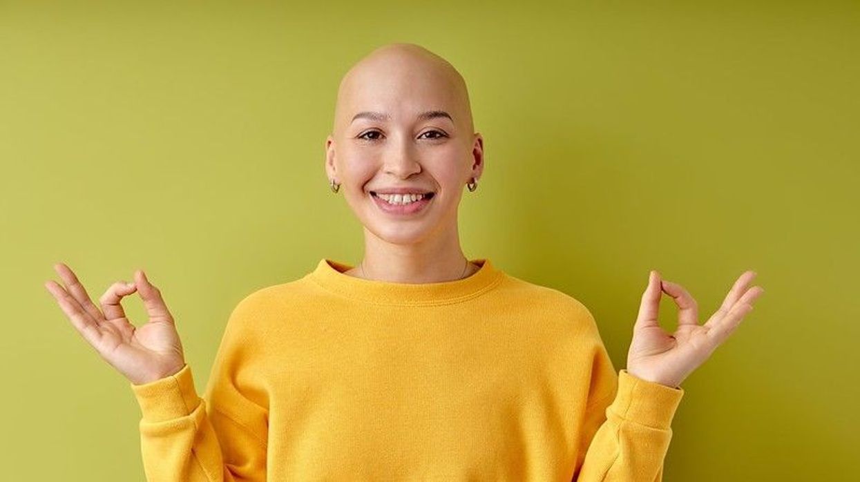 Happy and calm young bald woman