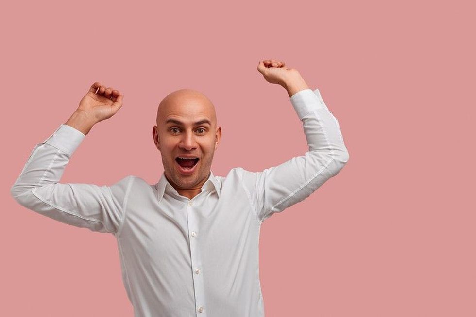Happy bald man wearing white shirt 