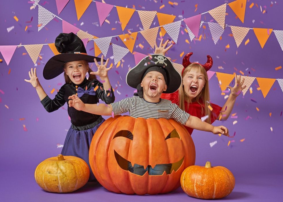 Happy brother and two sisters at Halloween