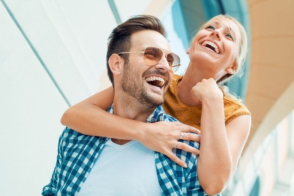 Happy couple in love having fun outdoors and smiling