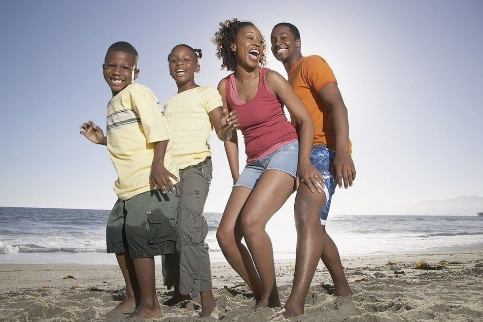 Happy family at beach on sunny day.