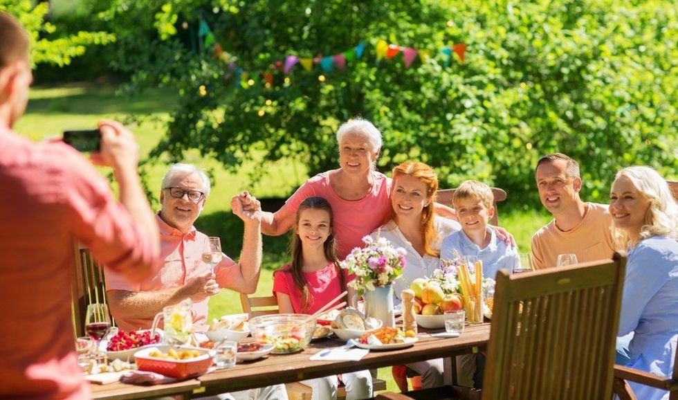 Happy family having summer garden party