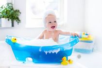 Happy laughing baby taking a bath playing with foam bubbles - Nicknames
