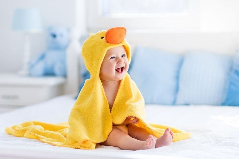 Happy laughing baby wearing yellow hooded duck towel - Nicknames