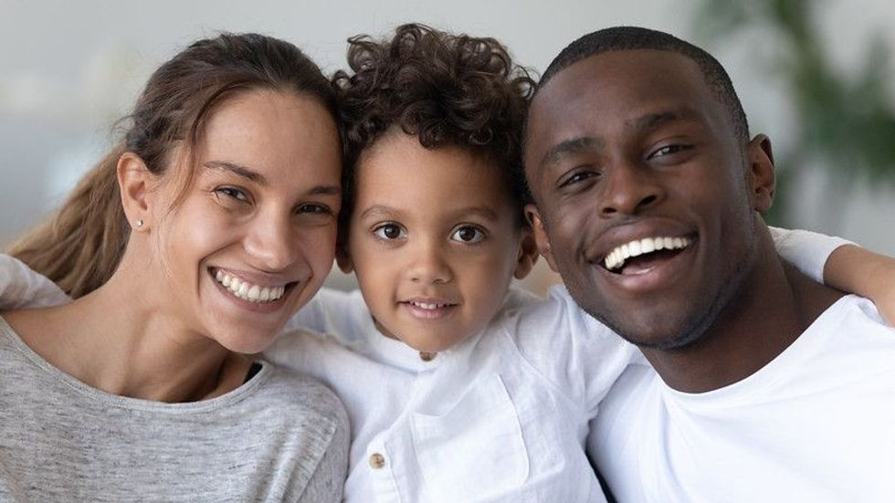 Happy mixed-ethnic family with their cute young son