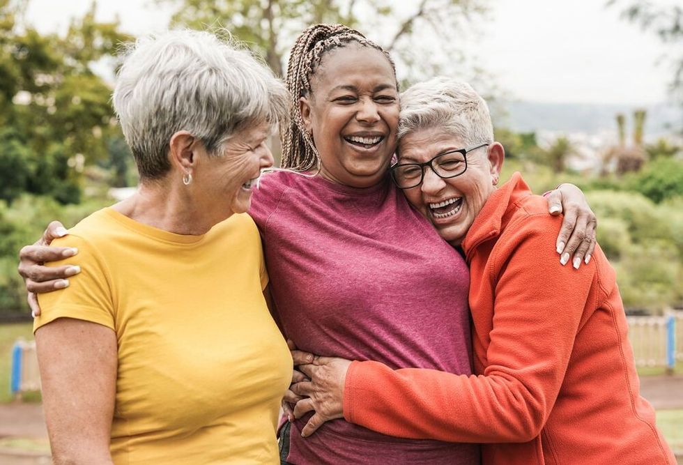Happy multiracial senior women having fun together outdoor 
