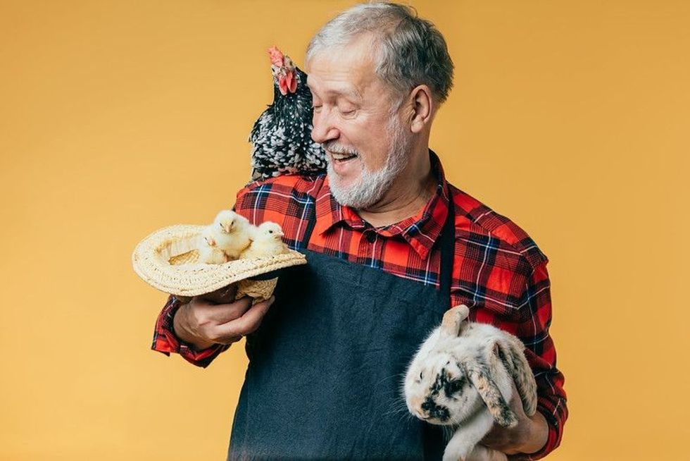 Happy old man with animals 