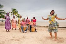 Happy woman dancing on drum beat in the Carribean beach party