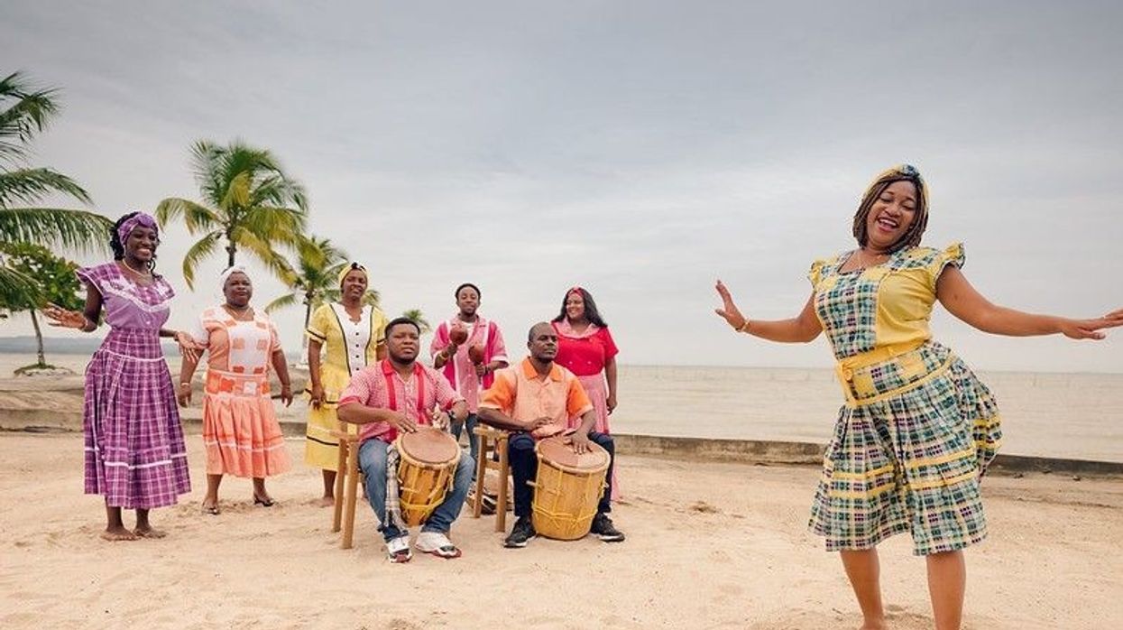 Happy woman dancing on drum beat in the Carribean beach party