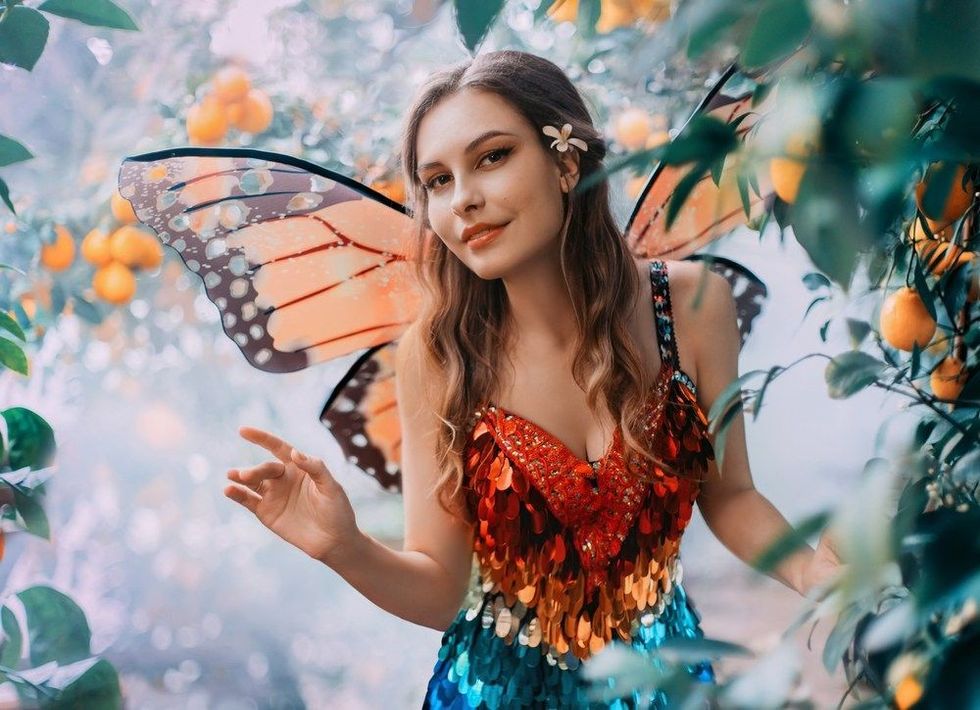Happy woman fairy walking in jungle.