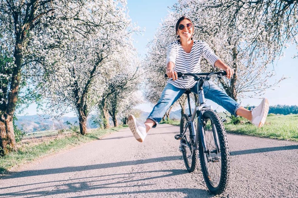 Happy woman on cycle during spring season