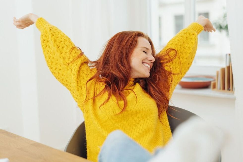 Happy woman stretching her arms out 
