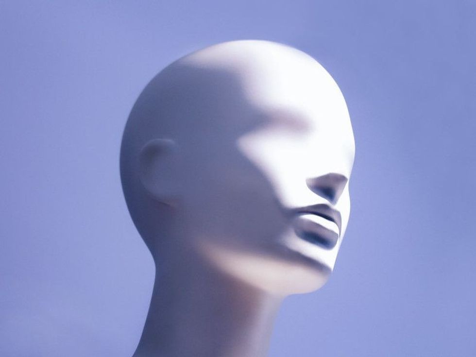Head of a white mannequin on a blue background.