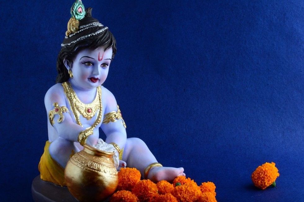 Hindu God Krishna on blue background.