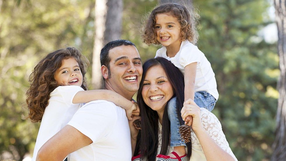 Hispanic family having fun outdoors.