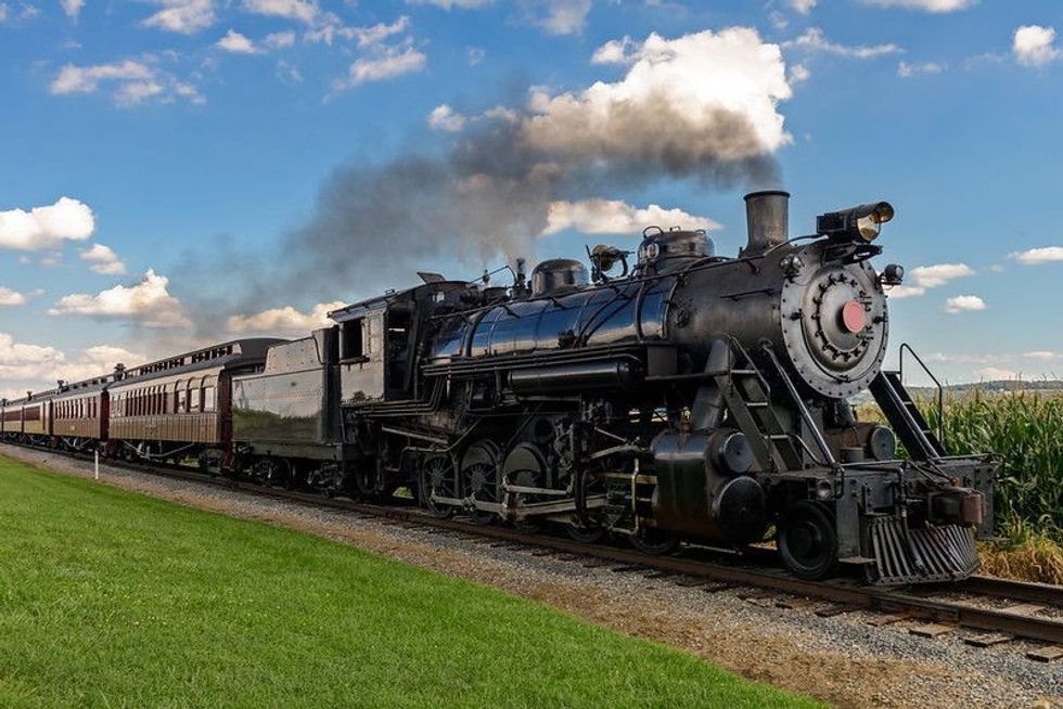 Historic steam train passing through the fields