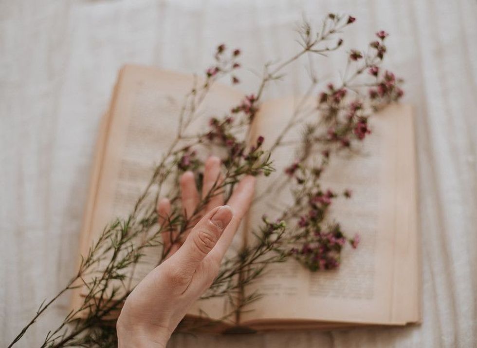 Holding flowers and a poetry book