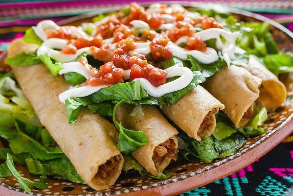 Homemade Mexican food flautas de pollo,Chicken tacos and spicy Salsa.