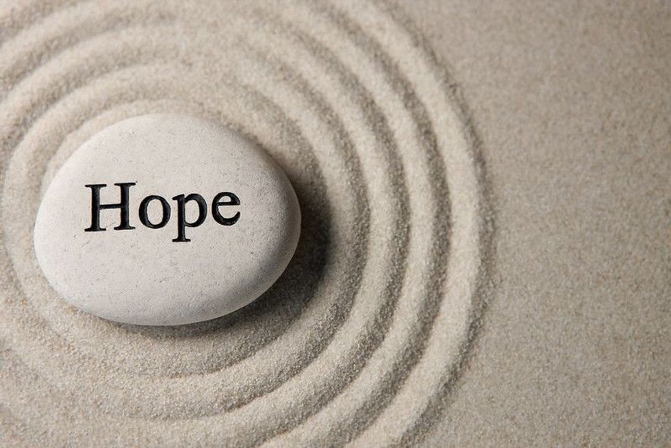 HOPE pebble creating ripples on sand.