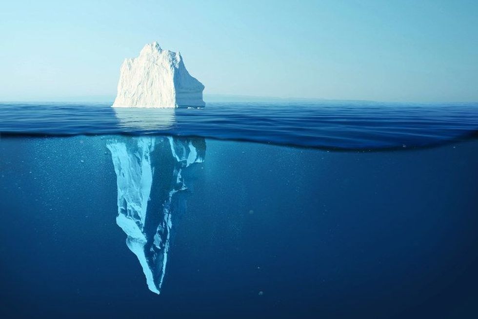 Iceberg in clear blue water