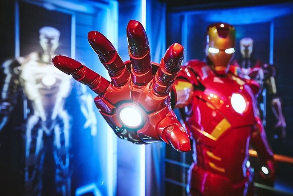Iron man fully suited with his arm stretched ready to fire.