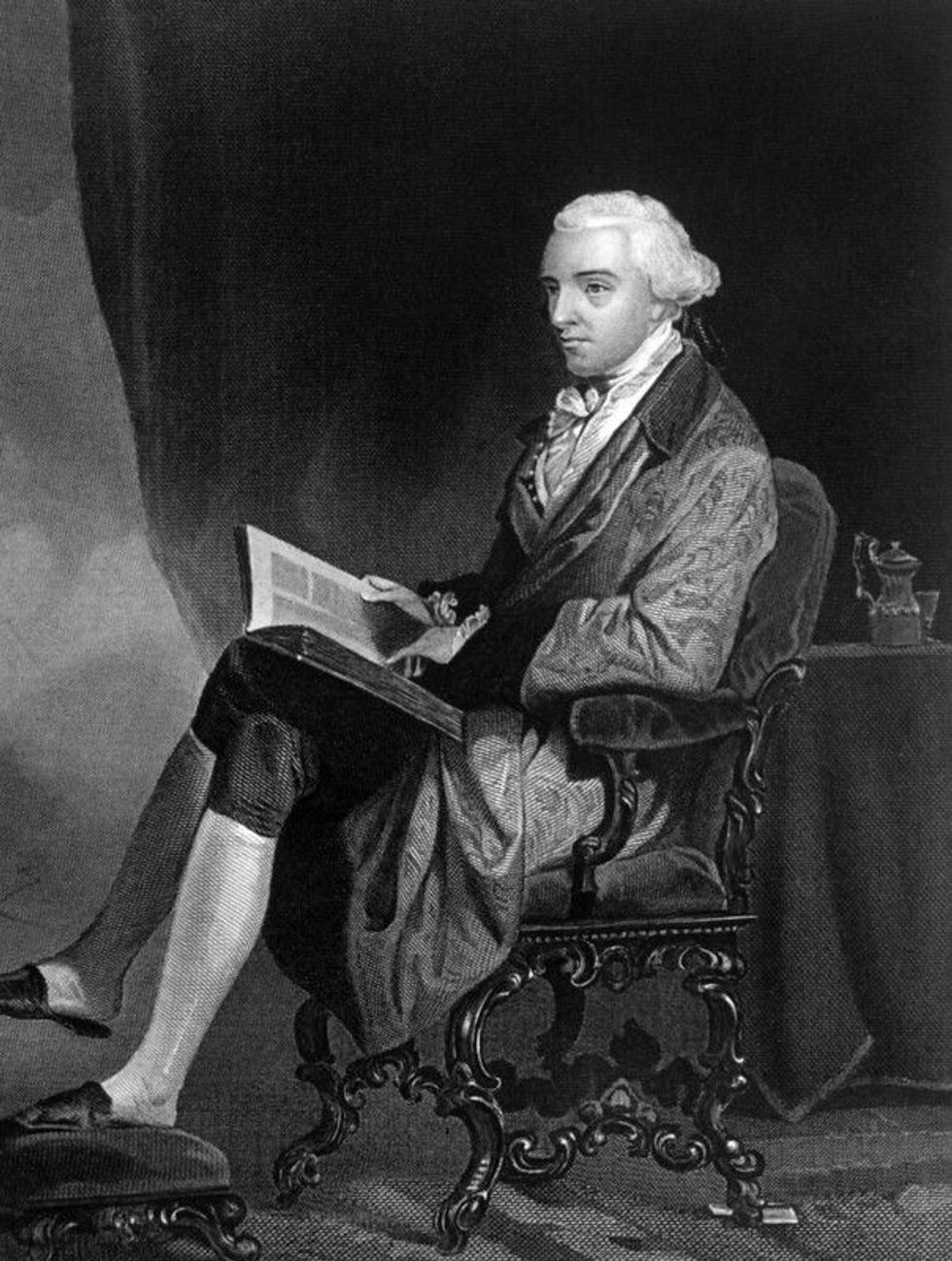 John Hancock sitting on a chair