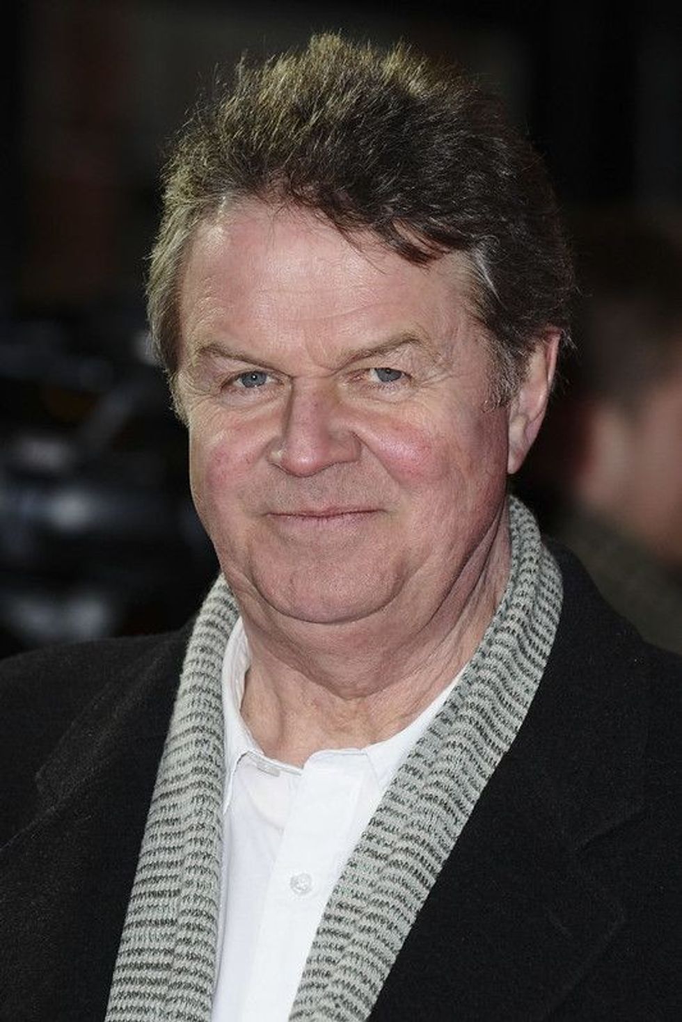 John Madden wearing black coat