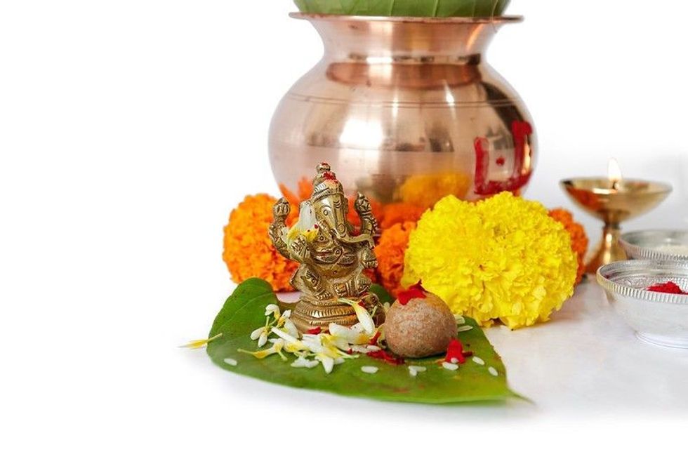 Kalash with coconut and betel leaf with flowers used for Ganesh Pujan during Akshay Tritiya